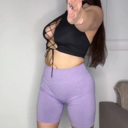 Active beauty stretching in her tight gym shorts and lace-up top. Only on OnlyFans