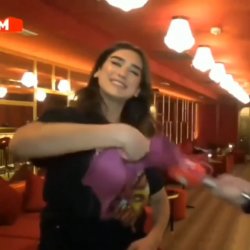 Dua Lipa takes off her bra