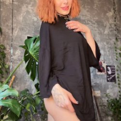 Thick thighs spread wide under loose shirt