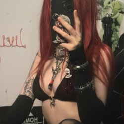 Black lace, red hair, and a soul you’ll never own